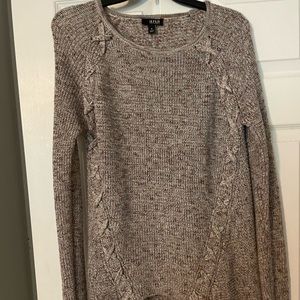 Oversized sweater with cross detailing on shoulders.